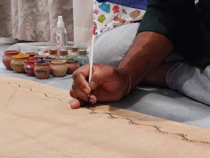Hand-painted Pattachitra silk saree, blending traditional art with modern couture